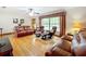 Relaxing living room with hardwood floors, leather furniture, and large window at 106 N Frederick St, Pierson, FL 32180