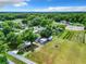 Aerial view of a house with large property, orchard, and farmland at 106 N Frederick St, Pierson, FL 32180