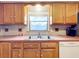 Kitchen featuring wood cabinets, double sink, and stainless steel dishwasher at 106 N Frederick St, Pierson, FL 32180