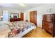 Spacious bedroom with floral bedding and hardwood floors at 106 N Frederick St, Pierson, FL 32180