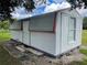Metal storage shed with a door and window at 106 N Frederick St, Pierson, FL 32180