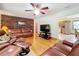 Spacious living room with hardwood floors, leather furniture, and brick accent wall at 106 N Frederick St, Pierson, FL 32180
