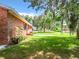 Spacious backyard with a large grassy area and mature trees at 106 N Frederick St, Pierson, FL 32180