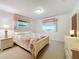 Bedroom with floral bedding and white wooden frame bed at 106 N Frederick St, Pierson, FL 32180