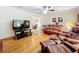 Living room with hardwood floors, leather furniture, and views to dining area at 106 N Frederick St, Pierson, FL 32180