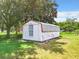 Metal storage shed with a single window at 106 N Frederick St, Pierson, FL 32180