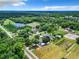 Aerial view of a large property with lush landscaping and multiple buildings at 106 N Frederick St, Pierson, FL 32180