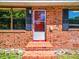 Brick house exterior with a red front door and shutters at 106 N Frederick St, Pierson, FL 32180