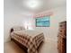Bedroom with plaid bedding and wood dresser at 106 N Frederick St, Pierson, FL 32180