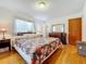 Main bedroom with floral bedding and hardwood floors at 106 N Frederick St, Pierson, FL 32180