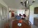 Dining area with wooden table and chairs, open to living room at 1612 Juno Trl, Astor, FL 32102