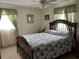 Bedroom with a wooden bed frame and patchwork quilt at 1612 Juno Trl, Astor, FL 32102