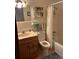 Bathroom with tub, toilet and wood vanity at 1612 Juno Trl, Astor, FL 32102