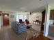 Bright living room with tiled floors and comfy seating at 1612 Juno Trl, Astor, FL 32102