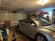 Garage with car, storage and workbench at 1612 Juno Trl, Astor, FL 32102