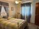 Bright bedroom with a double bed and blue curtains at 1612 Juno Trl, Astor, FL 32102