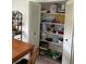 Well-stocked pantry with ample shelving for storage at 1612 Juno Trl, Astor, FL 32102