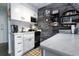 Charming kitchen with white cabinets and rustic wood accent wall at 2043 S Atlantic Ave # 308, Daytona Beach, FL 32118