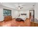 Bedroom with hardwood floors, ceiling fan, and a view of the backyard at 1582 Covered Bridge Dr, Deland, FL 32724