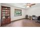 Home office featuring built-in shelving, hardwood floors, and large window at 1582 Covered Bridge Dr, Deland, FL 32724