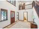 Two-story entryway with tile floors and chandelier at 1582 Covered Bridge Dr, Deland, FL 32724