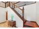 Elegant wooden staircase with ornate iron railing at 1582 Covered Bridge Dr, Deland, FL 32724