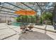 Relaxing poolside seating area under a covered patio at 1582 Covered Bridge Dr, Deland, FL 32724