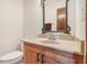 Light-filled bathroom with wood vanity, granite countertop, and updated sink at 1582 Covered Bridge Dr, Deland, FL 32724
