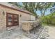 Stone and brick outdoor kitchen with bar seating at 1582 Covered Bridge Dr, Deland, FL 32724