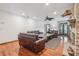 Living room with hardwood floors, leather sofas, and fireplace at 1582 Covered Bridge Dr, Deland, FL 32724