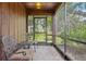 Cozy screened porch with seating area, perfect for enjoying the outdoors at 1582 Covered Bridge Dr, Deland, FL 32724