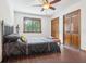 Bedroom with a ceiling fan, wood floors, and ample closet space at 1582 Covered Bridge Dr, Deland, FL 32724