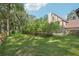Landscaped backyard with lush greenery and a wooden fence at 1582 Covered Bridge Dr, Deland, FL 32724