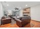 Spacious living room features hardwood floors, a fireplace, and comfortable leather seating at 1582 Covered Bridge Dr, Deland, FL 32724