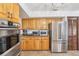 Stainless steel appliances and wood cabinets in this kitchen at 1582 Covered Bridge Dr, Deland, FL 32724