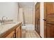 Clean bathroom with granite countertop, tub shower, and wood cabinets at 1582 Covered Bridge Dr, Deland, FL 32724