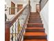 Wooden staircase with an iron railing and hardwood floors at 1582 Covered Bridge Dr, Deland, FL 32724