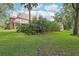 Two-story house with a red tile roof and a large backyard at 1582 Covered Bridge Dr, Deland, FL 32724