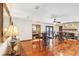 Open concept living space with hardwood floors, bar and kitchen views at 1582 Covered Bridge Dr, Deland, FL 32724
