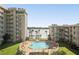 Community pool with surrounding patio furniture and waterfront views at 2711 N Halifax Ave # 296, Daytona Beach, FL 32118