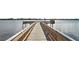 Steps leading to a wooden pier extending into the water at 2711 N Halifax Ave # 296, Daytona Beach, FL 32118