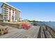 Relaxing area on the condo's private dock with red lounge chairs at 2711 N Halifax Ave # 296, Daytona Beach, FL 32118