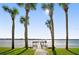 Pathway leading to a private pier with palm trees along the waterfront at 2711 N Halifax Ave # 296, Daytona Beach, FL 32118