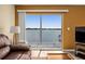 Living room with sliding doors leading to a balcony and water views at 2711 N Halifax Ave # 296, Daytona Beach, FL 32118