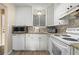 White kitchen with granite countertops and modern appliances at 2711 N Halifax Ave # 296, Daytona Beach, FL 32118