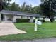 One story home with carport and mailbox at 1871 Riveredge Dr, Astor, FL 32102