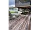 Spacious wooden deck with seating and view of canal at 1871 Riveredge Dr, Astor, FL 32102