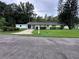 Single-story home with a carport, small shed, and a well-maintained lawn at 1871 Riveredge Dr, Astor, FL 32102