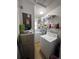 Functional laundry room with washer, dryer, and shelving at 1871 Riveredge Dr, Astor, FL 32102