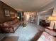 Open living and dining area with comfortable furniture and carpeted floors at 1871 Riveredge Dr, Astor, FL 32102